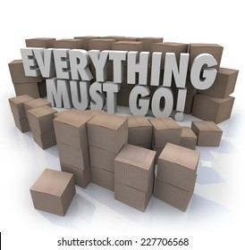 Everything Must Go words in 3d letters surrounded by cardboard boxes in a store warehouse to illustrate overstock inventory for a sale or clearnace event