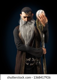 Evil Warlock Old Wizard Posing With Staff  On A Dark Background. 3d Rendering