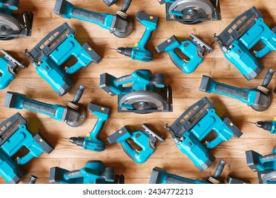 An expansive array of the latest cordless power tools neatly displayed against a wooden backdrop, highlighting essential equipment for home improvement and professional building tasks.