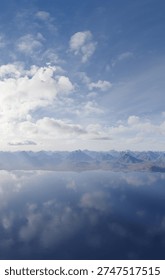 Expansive mountain range and calm reflective lake beneath a bright blue sky with soft clouds, 3d Rendering.