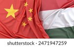 Fabric textures of china and hungary flags lying on top of each other