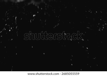 Falling Snow down On The Black Background. Blurry flecks snow overlay. White spots on black background. Abstract speckles overlay. Snowfall on black background - design element. For photo edit