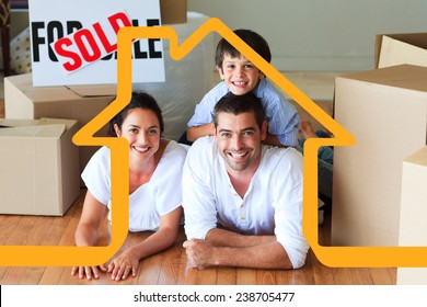 Family in their new house lying on floor with boxes against house outline - Powered by Shutterstock