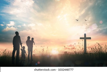 Family worship concept: Silhouette people looking for the cross on autumn sunrise background