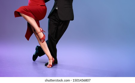 Feet Of Professional Tango Dancers In Dancing Movement On Bright Background Indoors