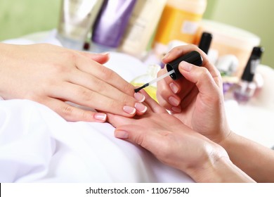 Female hands and manicure related objects in spa salon - Powered by Shutterstock