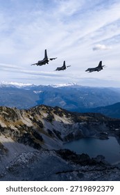 Fighter jets surge across a sharp mountain ridge, a dramatic alpine landscape showcasing precision flight. 3d Rendering Military Aircraft. Background image from British Columbia, Canada