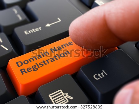 Finger Presses Orange Button Domain Name Registration on Black Keyboard Background. Closeup View. Selective Focus.