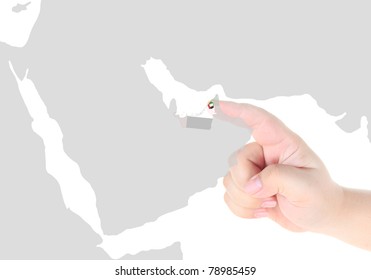 Finger touch on a future innovative transparent screen display Dubai map and flag