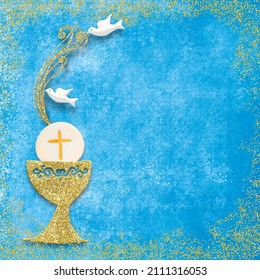 First holy communion invitation card. Golden chalice and doves on blue paper square  background with copy space to text and photo.