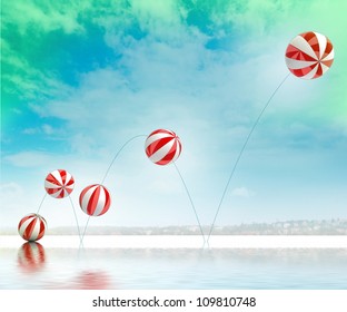 five jumping white red striped inflatable balls with beach and sea waterreflection cityscape background