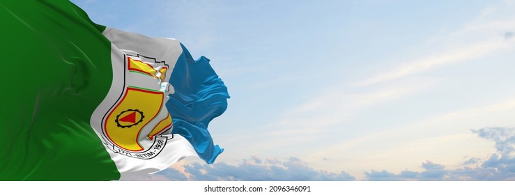 flag of Betim , Brazil at cloudy sky background on sunset, panoramic view. Brazilian travel and patriot concept. copy space for wide banner. 3d illustration
