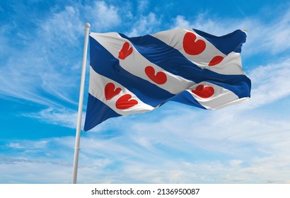 flag of Frisian , Netherlands at cloudy sky background on sunset, panoramic view. Dutch travel and patriot concept. copy space for wide banner. 3d illustration