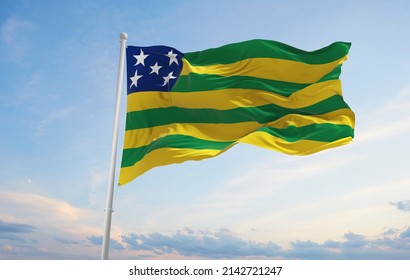 flag of Goias , Brazil at cloudy sky background on sunset, panoramic view. Brazilian travel and patriot concept. copy space for wide banner. 3d illustration