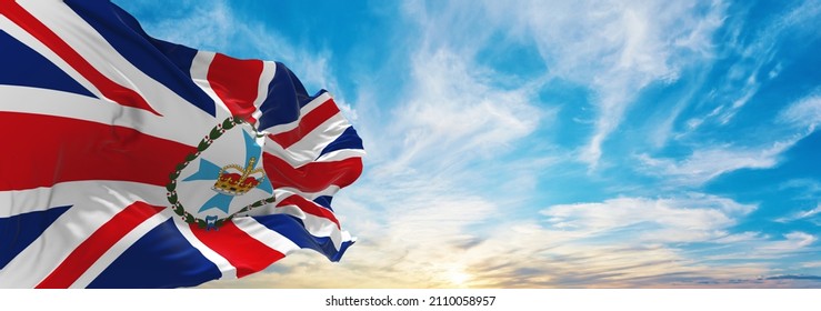 flag of Governor of Queensland , Australia at cloudy sky background on sunset, panoramic view. Australian travel and patriot concept. copy space for wide banner. 3d illustration