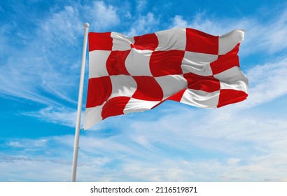 flag of North Brabant , Netherlands at cloudy sky background on sunset, panoramic view. Dutch travel and patriot concept. copy space for wide banner. 3d illustration