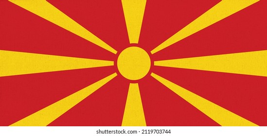 Flag of North Macedonia. North Macedonia state symbol. Flag on fabric surface. Fabric Texture. North Macedonia state symbol. National symbol. Republic of North Macedoni