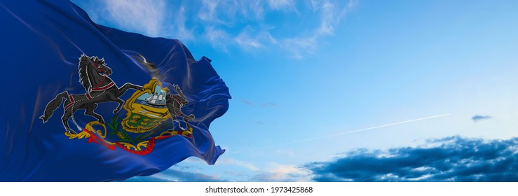 flag of Pennsylvania at cloudy sky background on sunset. Patriotic concept about state. 3d illustration