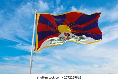 flag of Tibet at cloudy sky background on sunset, panoramic view. People's Republic of China. copy space for wide banner. 3d illustration