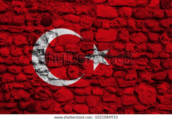 Flag of Turkey on a stone\
wall