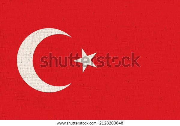 Flag of Turkey. Turkish flag on fabric surface.\
Fabric texture. National symbol of Turkey on patterned background.\
Republic of Turkey