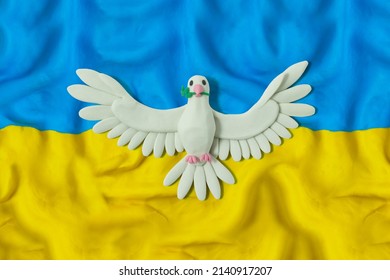 Flag of Ukraine with bird of peace. Pray for Ukraine. Stop Ukraine war. Blue and yellow. Handmade from plasticine. 3D artwork