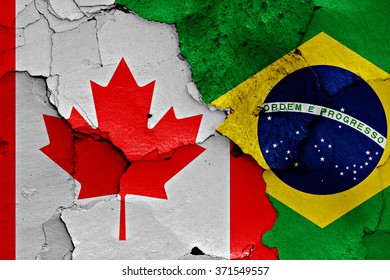 flags of Canada and Brazil painted on cracked wall