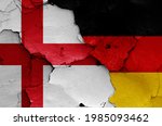 flags of England and Germany painted on cracked wall