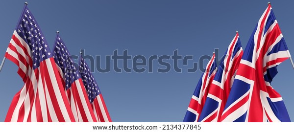 Flags of\
Great Britain and USA on flagpoles on a blue background. Flags on\
the sides in the center of the empty space. Place for text. British\
flag. London. America. 3D\
illustration.