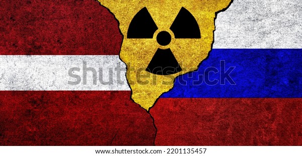 Flags\
of Latvia, Russia and radiation symbol together. Russia and Latvia\
Nuclear deal, threat, agreement, tensions\
concept