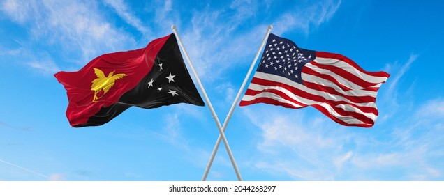 flags of USA and Papua New Guinea waving in the wind on flagpoles against the sky with clouds on sunny day. Symbolizing relationship, dialog between two countries. 3d illustration,