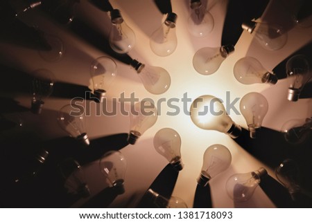 Flat lay picture of switch off light bulbs except one turned on. Idea or leadership concept. 3D rendering illustration.