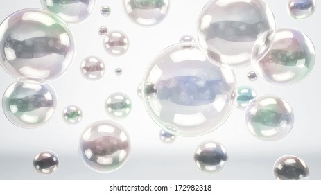 Floating Reflective Bubbles Or Glass Spheres Over A Bright White Cyc Background