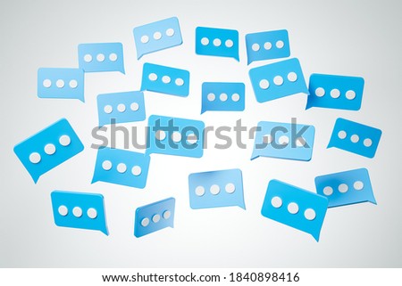 Flying blue message cloud boxes with dots over white background. Internet communication and social network concept. 3d render illustration.