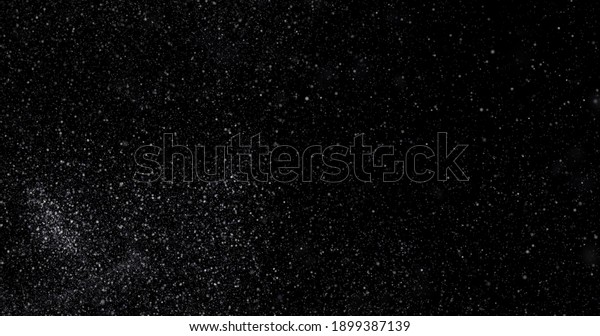 Flying dust\
particles on a black\
background