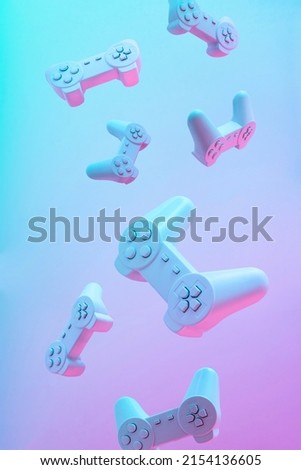 Flying or levitate pattern of game pad joystick on purple pink and blue color background. Minimal abstract creative idea. Gaming futuristic concept. 3d render.