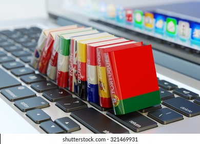 Foreign languages learn and translate education concept, books with covers in colors of national flags of world countries on computer laptop keyboard