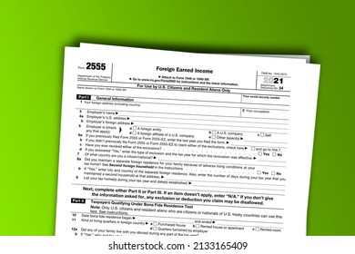Form 2555 papers. Foreign Earned Income. Form 2555 documentation published IRS USA 44480. American tax document on colored