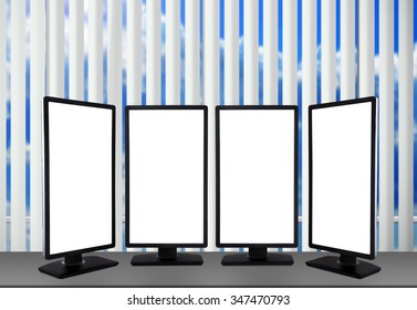 Four Blank Monitor Standing On Table In Modern Office