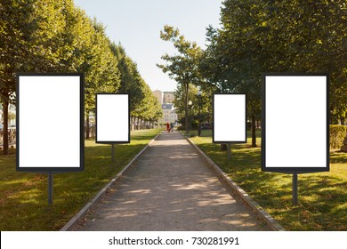 Four Blank Street Billboard Posters In Row In Urban Park. 3d Illustration.