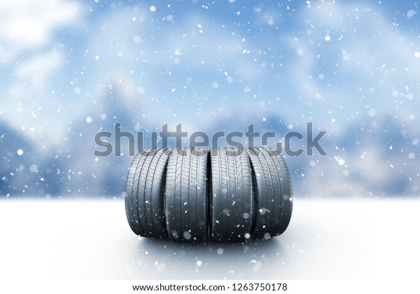 Four\
car tires on a snow covered road, 3d\
illustration