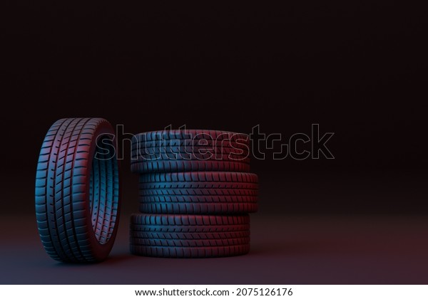 Four car tires stacked on a\
black background and patterned with blue and red lights. 3d\
illustration