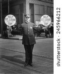 Fourth Liberty Loan Campaign during WWI. St. Louis traffic policeman using 4th Liberty Loan fans for signals. Fans read, 