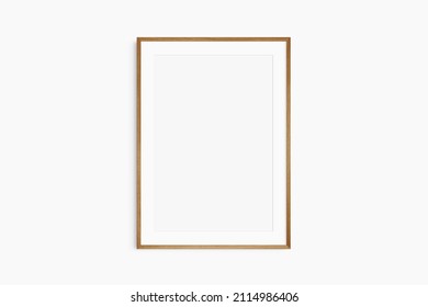 Frame mockup 5x7, 50x70, A4, A3, A2, A1. Single cherry wood frame mockup. Clean, modern, minimalist, bright. Portrait. Vertical. Passepartout (mat) opening in 2:3 aspect ratio.