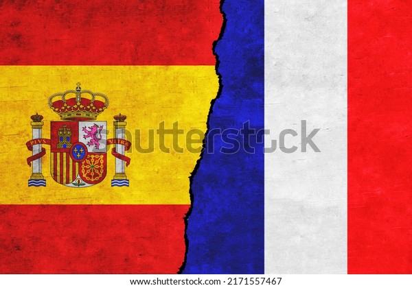France and\
Spain painted flags on a wall with a crack. Spain and France\
relations. France and Spain flags\
together