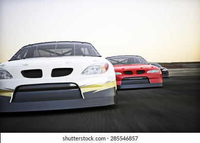 Front View Of Auto Racing Race Cars Racing On A Track With Motion Blur. 