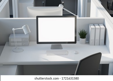 Front View Of Blank Mock Up Computer Screen Standing On White Table In Office Cubicle. Concept Of Advertising And Product Placement. 3d Rendering