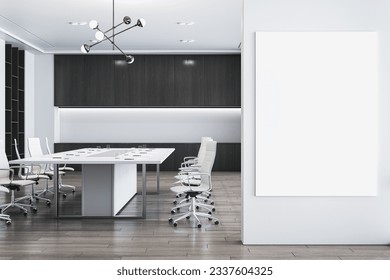 Front view of blank white picture frame on light grey wall and modern empty meeting room on a background, mockup. 3D Rendering