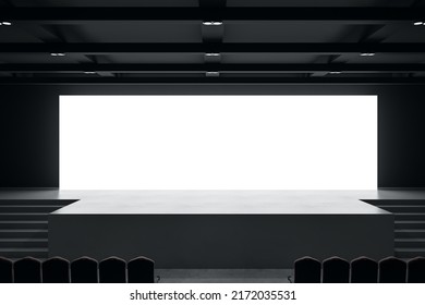 Front View On Big Blank White Illuminated Screen With Space For Your Text Or Logo In Empty Huge Hall With Scene, Stairs And Rows Of Seats. 3D Rendering, Mockup