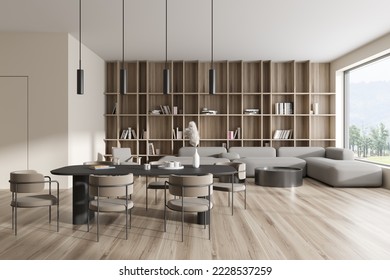 Front view on bright studio room interior with armchairs, sofa, dining table, coffee table, bookshelf, white wall, panoramic window, oak wooden floor. Concept of minimalist design. 3d rendering